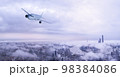 雲の上を飛行する飛行機 98384086