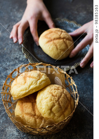 おやつのメロンパンを食べる子ども おやつのメロンパンを食べる子ども 98385163