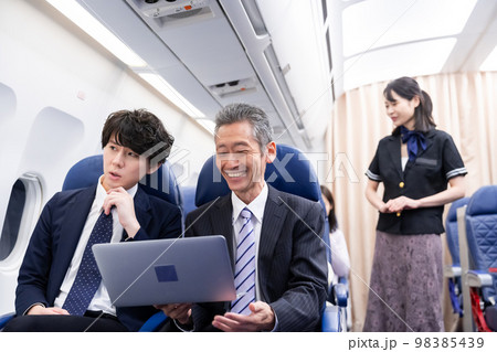 笑顔でお客様の対応をするキャビンアテンダント 98385439