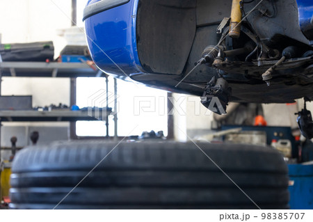 Car service center concept, vehicle raised on lift at maintenance station, auomobile repair, check up, repairing the car 98385707