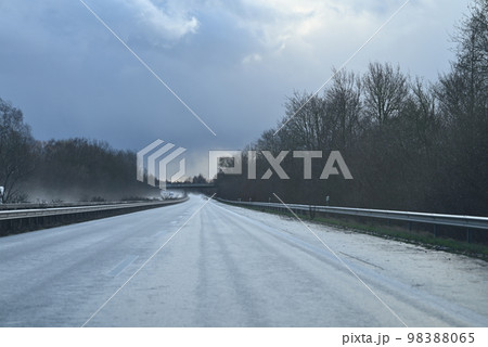 Wet highway against a dramatic sky on a stormy day 98388065