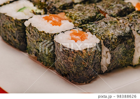 Rolls with salmon macro photo. Food delivery. Japanese cuisine rolls. 98388626