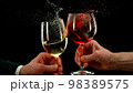 Two men clinking with glasses of wine, celebrating success. 98389575