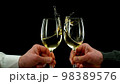 Two men clinking with glasses of white wine, celebrating success. 98389576