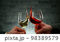 Two men clinking with glasses of wine, celebrating success. 98389579