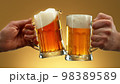 Two glasses of beer in cheers gesture, splashing. 98389589