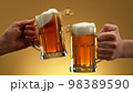 Two glasses of beer in cheers gesture, splashing. 98389590