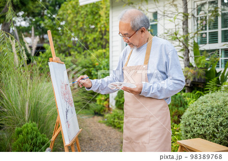 Artist. Asian senior old man painting picture using brush and oil color on canvas, lifestyle elderly people smile paint at his easel, Happy retirement and activity concept Artist. Asian senior old man painting picture using brush and oil color on canvas, lifestyle elderly people smile paint at his easel, Happy retirement and activity concept 98389768