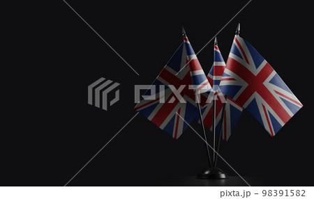 Small national flags of the United Kingdom on a black background 98391582