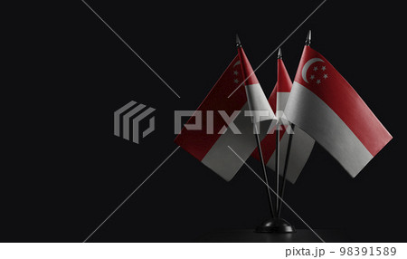Small national flags of the Singapore on a black background Small national flags of the Singapore on a black background 98391589