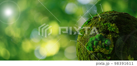 Model of the green planet Earth from moss with wind turbines.  98391611