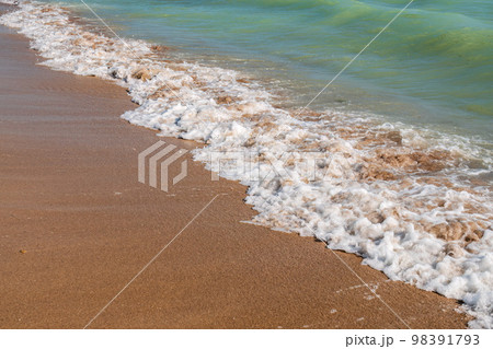 Soft wave of the sea on the sandy beach. 98391793