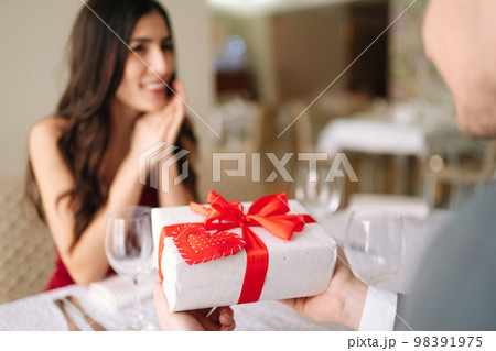 Valentine's Day concept. Happy couple in love. Couple celebrating Valentine's Day in restaurant. Valentine's Day concept. Happy couple in love. Couple celebrating Valentine's Day in restaurant. 98391975