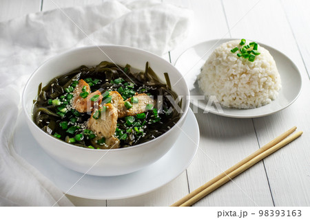 Korean seaweed soup with meat in a white bowl and boiled rice. Birthday soup. Traditional Korean cuisine. Healthy Eating. Pregnancy. Custom. 98393163