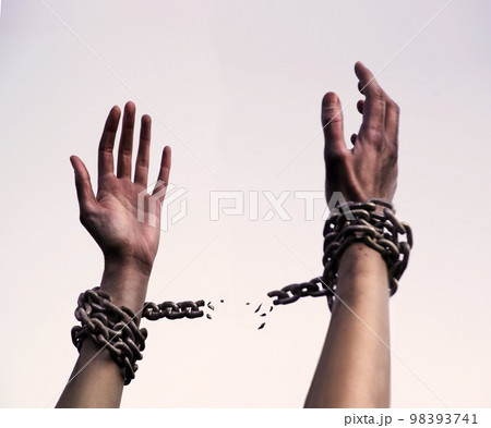 Praying man with shackled hands 98393741