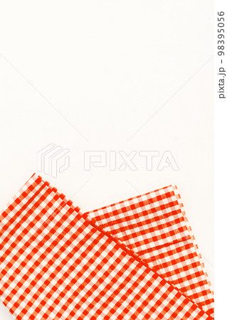 Orange cloth, a kitchen towel with a checkered pattern, on a whi Orange cloth, a kitchen towel with a checkered pattern, on a whi 98395056