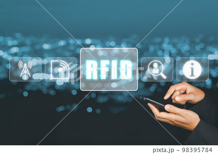 RFID, Radio frequency identification concept, Person using laptop computer and hand touching RFID icon on virtual screen. RFID, Radio frequency identification concept, Person using laptop computer and hand touching RFID icon on virtual screen. 98395784