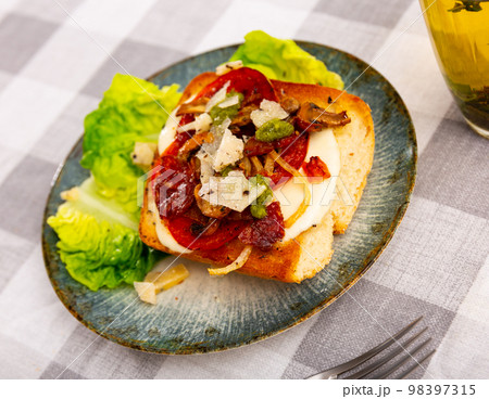 Baked sandwich with tomatoes, mushrooms, chorizo sausage and parmesan Baked sandwich with tomatoes, mushrooms, chorizo sausage and parmesan 98397315