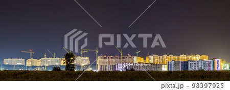 Panorama night view of many building cranes at construction site of new modern residential area Panorama night view of many building cranes at construction site of new modern residential area 98397925