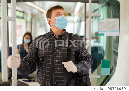 Man in medical mask in tram 98398080