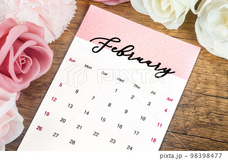 The February 2023 Monthly calendar for 2023 year with pink rose on wooden background. 98398477
