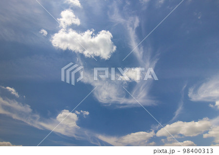 Dramatic blue sky with puffy white clouds in bright clear sunny day Dramatic blue sky with puffy white clouds in bright clear sunny day 98400313