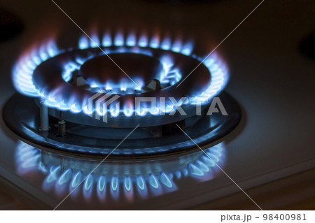Closeup shot of blue fire from domestic kitchen stove. Gas cooker with burning flames propane gas. Closeup shot of blue fire from domestic kitchen stove. Gas cooker with burning flames propane gas. 98400981