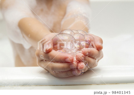 Childs little girls hands in bath with soap bubbles in it. Hygiene concept. Childs little girls hands in bath with soap bubbles in it. Hygiene concept. 98401345