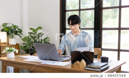 College student is analyzing data or doing homework assignments in own house, Work from home, Use your laptop to search for information and educate yourself at home, Stay home, Internet learning. 98405569