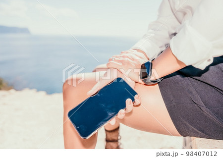 Woman sea laptop. Business woman in yellow hat freelancer with laptop working over blue sea beach. Girl relieves stress from work. Freelance, digital nomad, travel and holidays concept 98407012