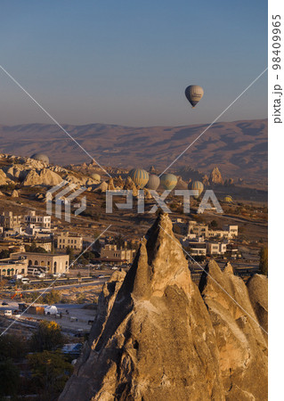 Cappadocia. View of Goreme town with caves and hot air balloons in Cappadocia. Turkey. Cappadocia. View of Goreme town with caves and hot air balloons in Cappadocia. Turkey. 98409965