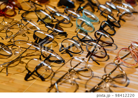 large selection of sunglasses and glasses on a stand 98412220