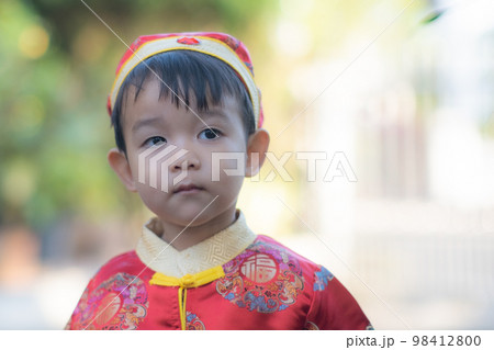 Asian baby boy smiling with traditional Chinese outfit. Dress up for Chinese new year festival Asian baby boy smiling with traditional Chinese outfit. Dress up for Chinese new year festival 98412800