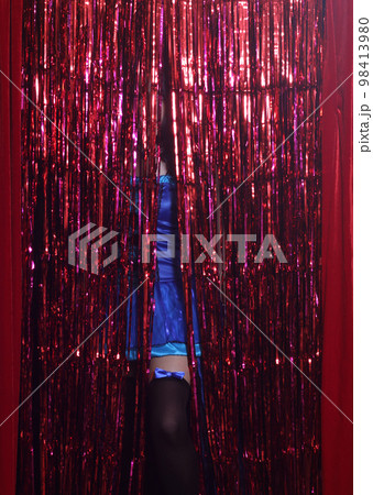 Woman Preforming Burlesque on Stage. Blue Corset Costume With Red Background Woman Preforming Burlesque on Stage. Blue Corset Costume With Red Background 98413980
