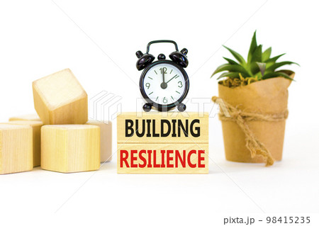 Building resilience symbol. Concept word Building resilience typed on wooden blocks. Beautiful white table white background. Black alarm clock. Business and building resilience concept. Copy space. Building resilience symbol. Concept word Building resilience typed on wooden blocks. Beautiful white table white background. Black alarm clock. Business and building resilience concept. Copy space. 98415235