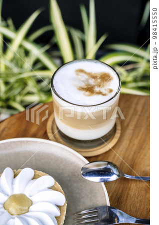 Coffee and cake on a cafe table outside. Morning, drink, good mood concept 98415550