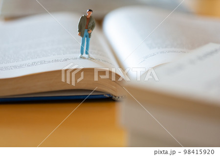 机の上に開いた英語の書籍 研究 学習 学び直しのイメージ 男性フィギア 机の上に開いた英語の書籍 研究 学習 学び直しのイメージ 男性フィギア 98415920