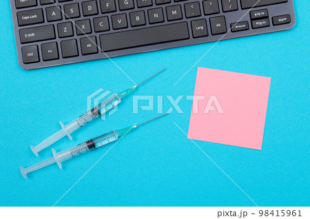 Vaccination or Revaccination Concept - Two Medical Syringe on Blue Table 98415961