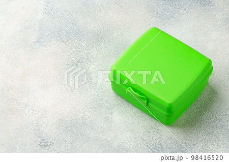 New plastic lunch box on a gray background New plastic lunch box on a gray background 98416520