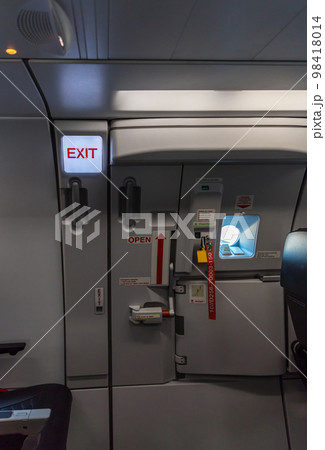 Exit sign in passenger airplane. Exit sign in passenger airplane. 98418014