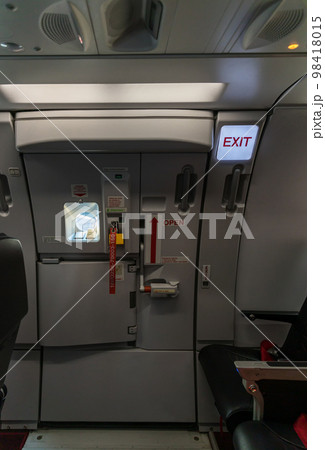 Exit sign in passenger airplane. 98418015