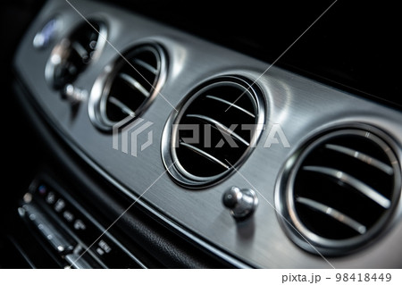 Ventilation and air conditioning vents in the interior of a car 98418449
