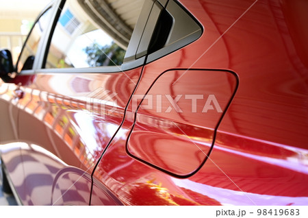 gas tank of glossy red car, transportation industry 98419683