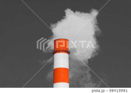 Pollution of the environment, ecology and air. Withdrawal of combustion products of soot, smoke and gases from the pipe of an industrial plant into the atmosphere against the background of a gray sky Pollution of the environment, ecology and air. Withdrawal of combustion products of soot, smoke and gases from the pipe of an industrial plant into the atmosphere against the background of a gray sky 98419981