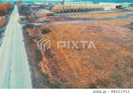Aerial view of countryside and straight country road. Farmland in autumn 98421452