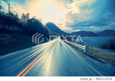 Highway at sunset. The road along the fjord 98421650