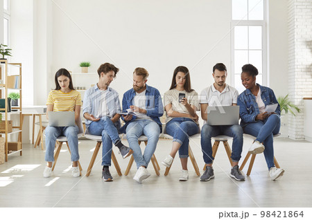 Group of students using modern digital devices at meeting 98421864