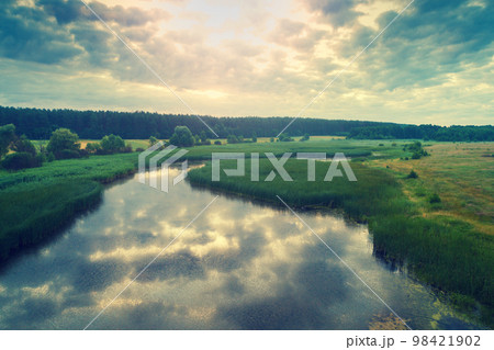 Aerial view of countryside and brook in evening at sunset light. Beautiful nature landscape Aerial view of countryside and brook in evening at sunset light. Beautiful nature landscape 98421902