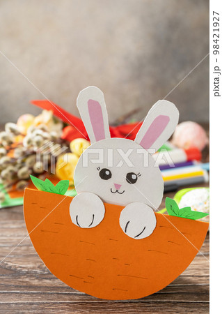 Easter card gift Easter bunny on a wooden table. Copy space. Handmade. Project of children's creativity, handicrafts, crafts for kids. Easter card gift Easter bunny on a wooden table. Copy space. Handmade. Project of children's creativity, handicrafts, crafts for kids. 98421927