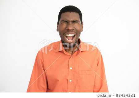 Portrait of frustrated young man screaming over white background 98424231